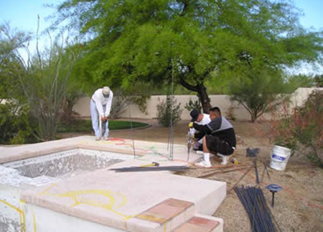 Swimming pool resurfacing team at work