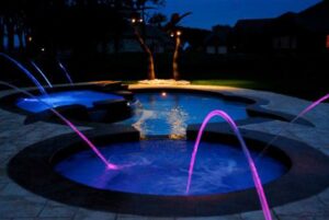 benefits of hot tubs combined with a clients colorful swimming pool lighting as water features