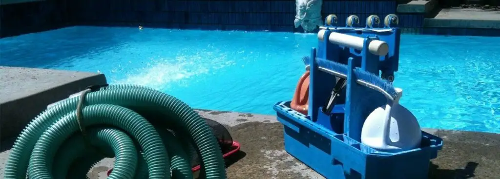 Pool cleaning supplies beside a pool