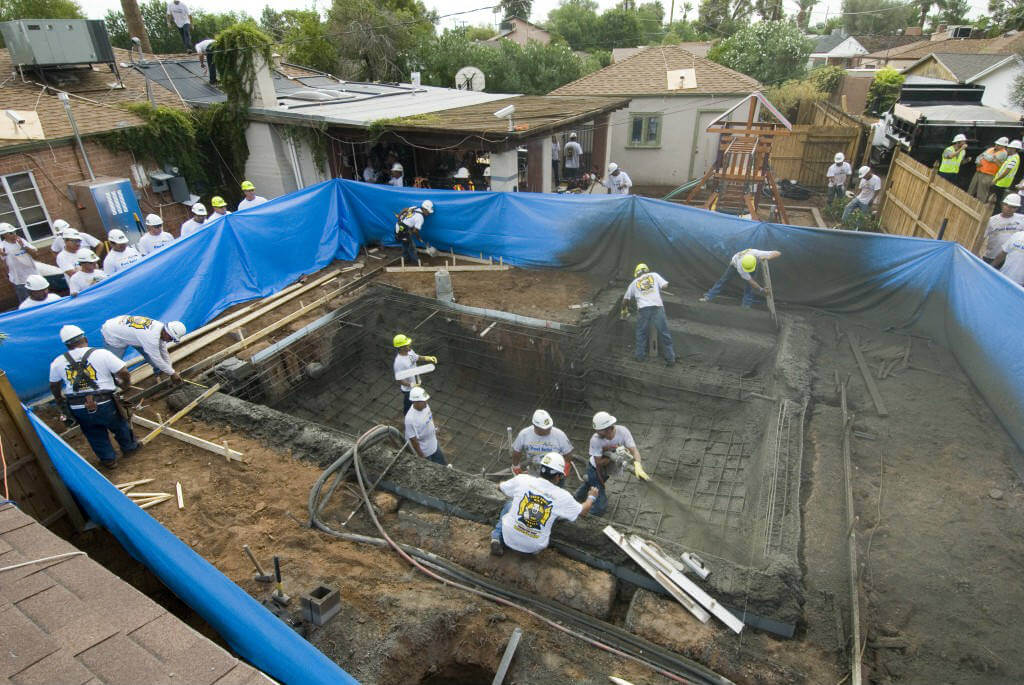 spraying concrete in corners of worlds fastest swimming pool build