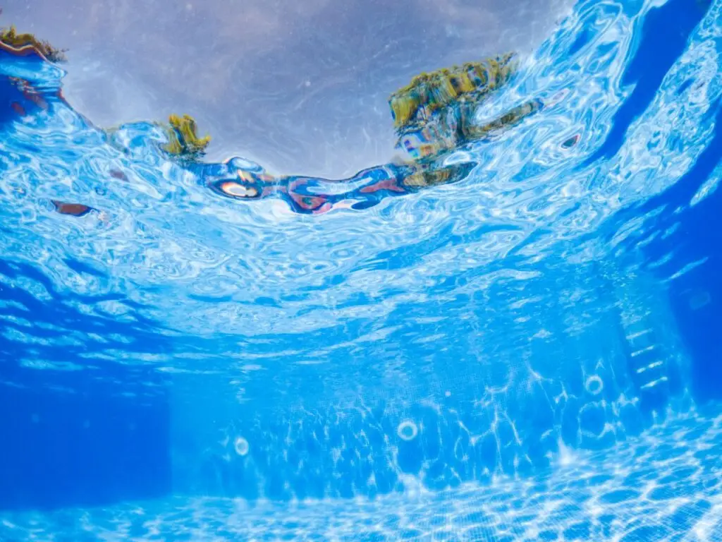 Underneath the water in a swimming pool