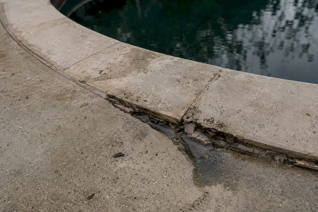 Cracked pool coping with water damage