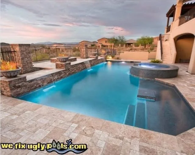 Twilight Arizona backyard pool remodel by We Fix Ugly Pools with fire bowls, spillover spa and stone water features
